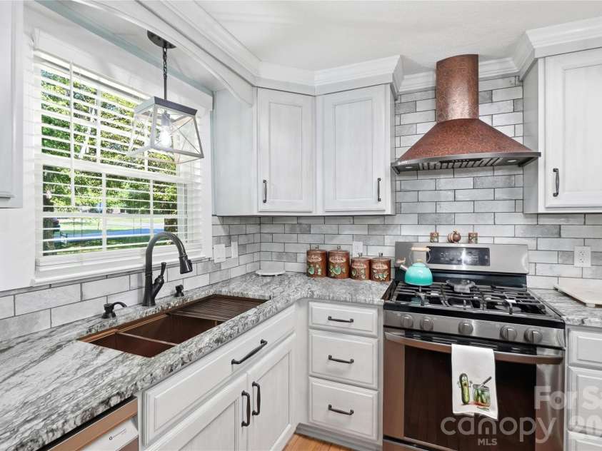 1690 26th Street, Hickory, NC 28601.  MLS# CAR4419006, YatesRealty ID 49464. Oversized sink, gas range and copper hood