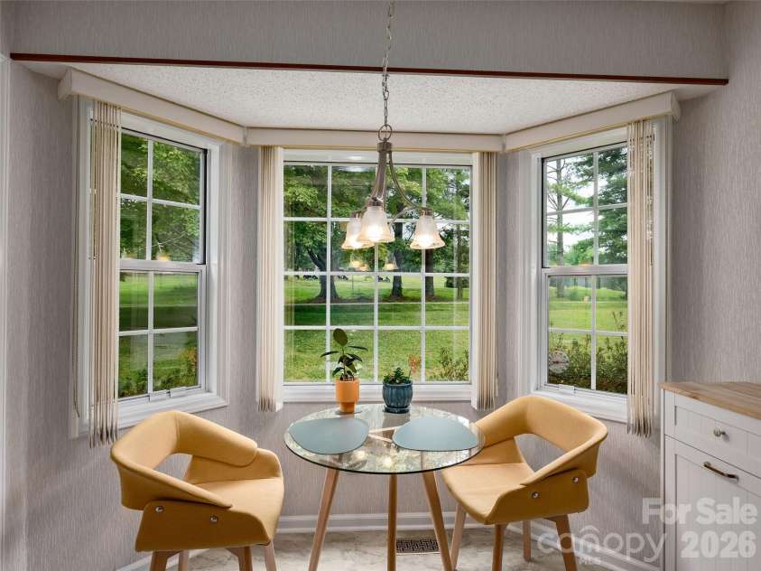 5 St Andrews Drive, Etowah, NC 28729.  MLS# CAR4419907, YatesRealty ID 49514. Bright breakfast area surrounded by windows creates an inviting spot for morning coffee or casual dining.