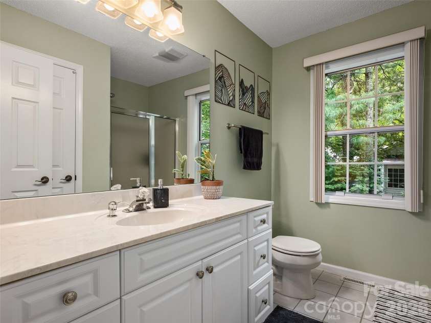 5 St Andrews Drive, Etowah, NC 28729.  MLS# CAR4419907, YatesRealty ID 49514. Full guest bathroom with spacious vanity and bright natural light.