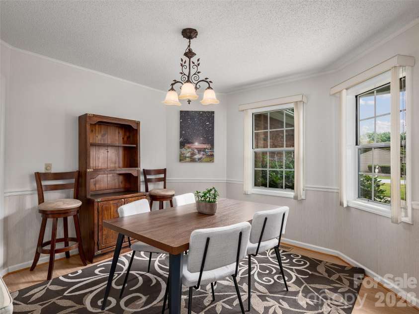 5 St Andrews Drive, Etowah, NC 28729.  MLS# CAR4419907, YatesRealty ID 49514. Light-filled dining room with multiple windows.  Perfect for family dinners or entertaining