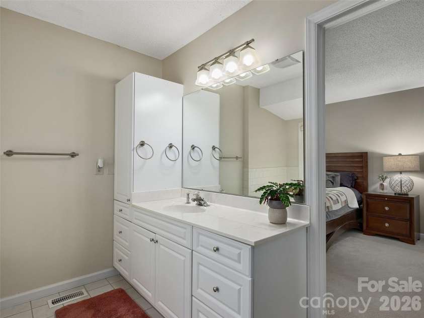 5 St Andrews Drive, Etowah, NC 28729.  MLS# CAR4419907, YatesRealty ID 49514. Primary bathroom features a large vanity with generous counter and storage space