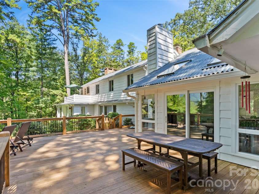 566 Canebrake Road, Tryon, NC 28782.  MLS# CAR4299420, YatesRealty ID 4954. Massive new deck off of primary bedroom and main section of home has year round mountain views.