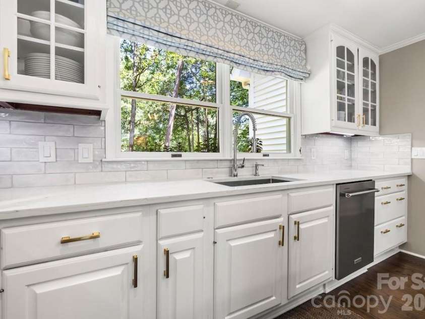 4234 Rotunda Road, Charlotte, NC 28226.  MLS# CAR4419685, YatesRealty ID 49567. Kitchen has double windows for light , S/S farm sink, subway tile backsplash, quartz conters