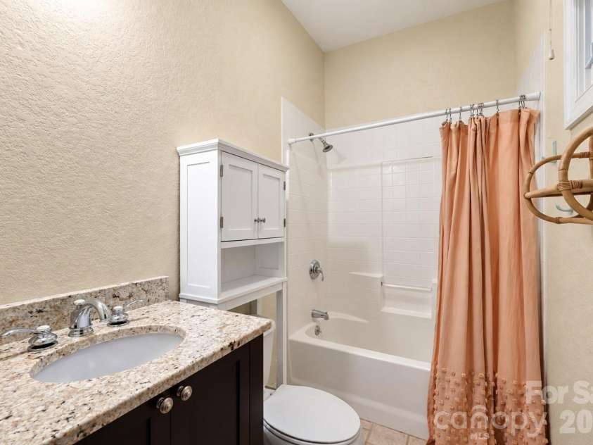 312 Forest Place, Candler, NC 28715.  MLS# CAR4419930, YatesRealty ID 49569. Downstairs en suite bathroom.