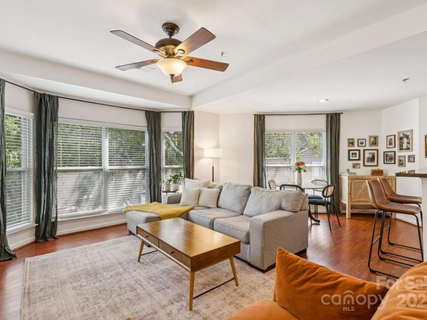 509 Graham Street, Charlotte, NC 28202.  MLS# CAR4292760, YatesRealty ID 4960. Bright, open living room with beautiful bay windows, tray ceiling, and a cozy, wood-burning fireplace.