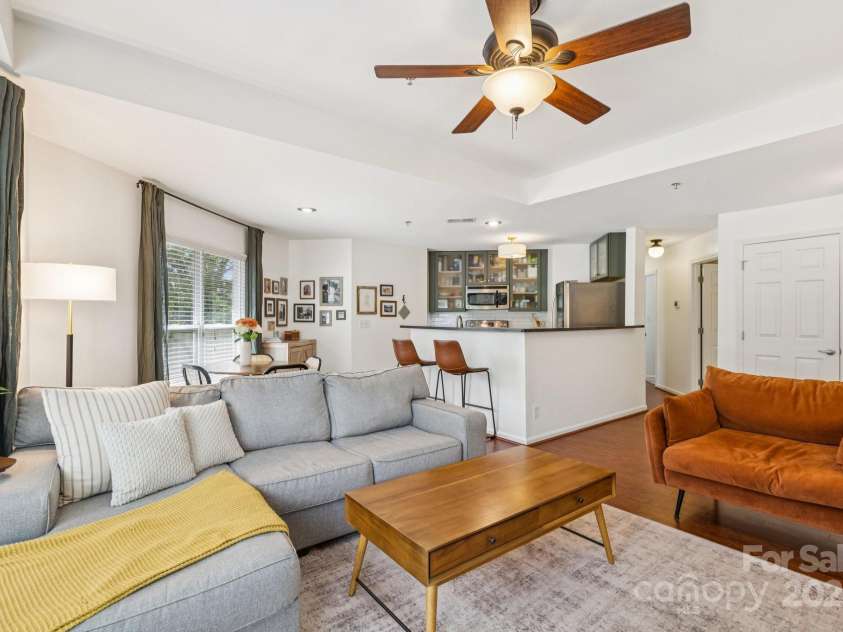 509 Graham Street, Charlotte, NC 28202.  MLS# CAR4292760, YatesRealty ID 4960. Bright, open living room with beautiful bay windows, tray ceiling, and a cozy, wood-burning fireplace.