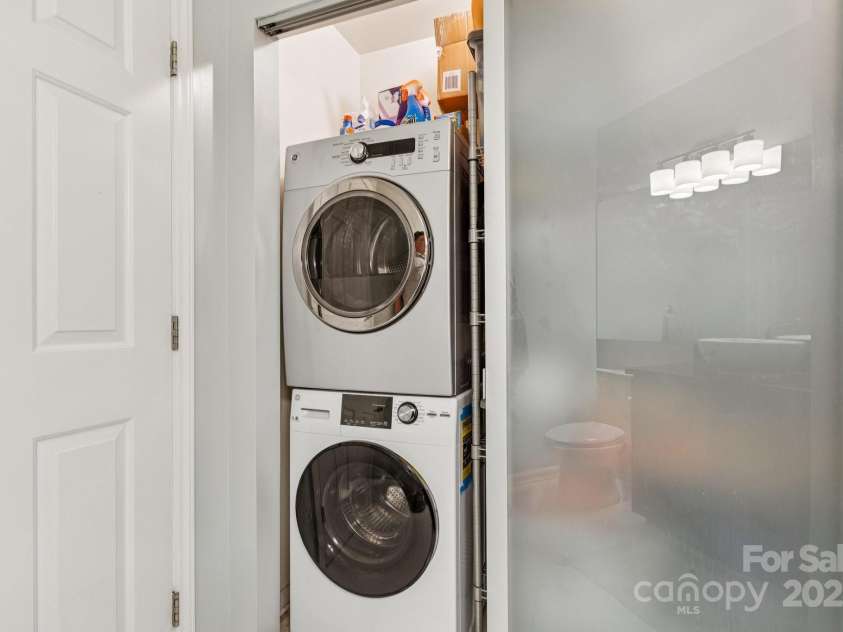 509 Graham Street, Charlotte, NC 28202.  MLS# CAR4292760, YatesRealty ID 4960. Stackable laundry unit with ample storage right next to it in the hallway half bathroom.