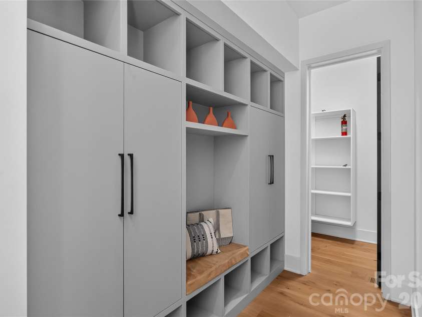 5620 Merry Mount Drive, Charlotte, NC 28226.  MLS# CAR4420251, YatesRealty ID 49600. Custom drop zone off the garage featuring built-in cabinetry, integrated cubbies, and bench seating for organized entry.