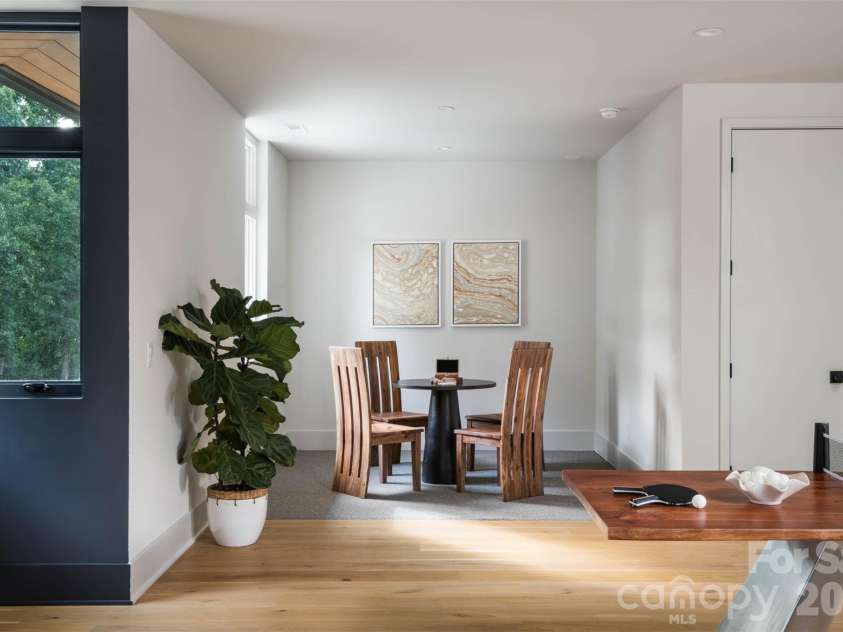 5620 Merry Mount Drive, Charlotte, NC 28226.  MLS# CAR4420251, YatesRealty ID 49600. Upper-level recreation room presenting a versatile game layout with light-filled dining nook and seamless hardwood flooring.