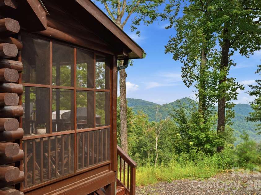 2235 Buck Mountain Road, Purlear, NC 28665.  MLS# CAR4422892, YatesRealty ID 49609. Screened Porch - Off Dining Area