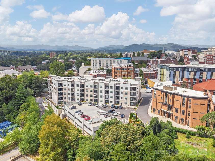 55 Market Street, Asheville, NC 28801.  MLS# CAR4285668, YatesRealty ID 4962. Drone shot of the back of 55 S Market so you can see the attached parking deck on the east side of the building.