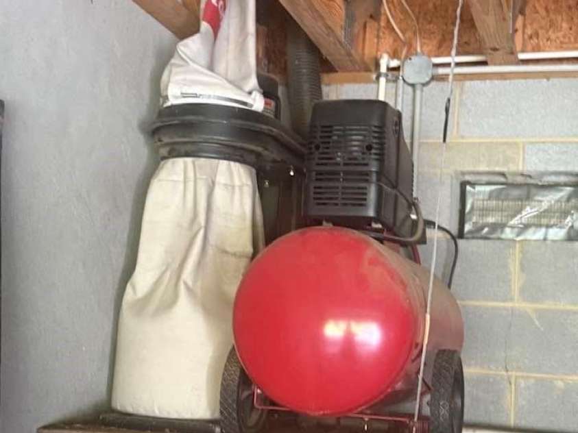 977 Morning Ride Drive, Columbus, NC 28722.  MLS# CAR4419017, YatesRealty ID 49673. Air compressor and dust collection system in lower garage, for use in overhead workshop