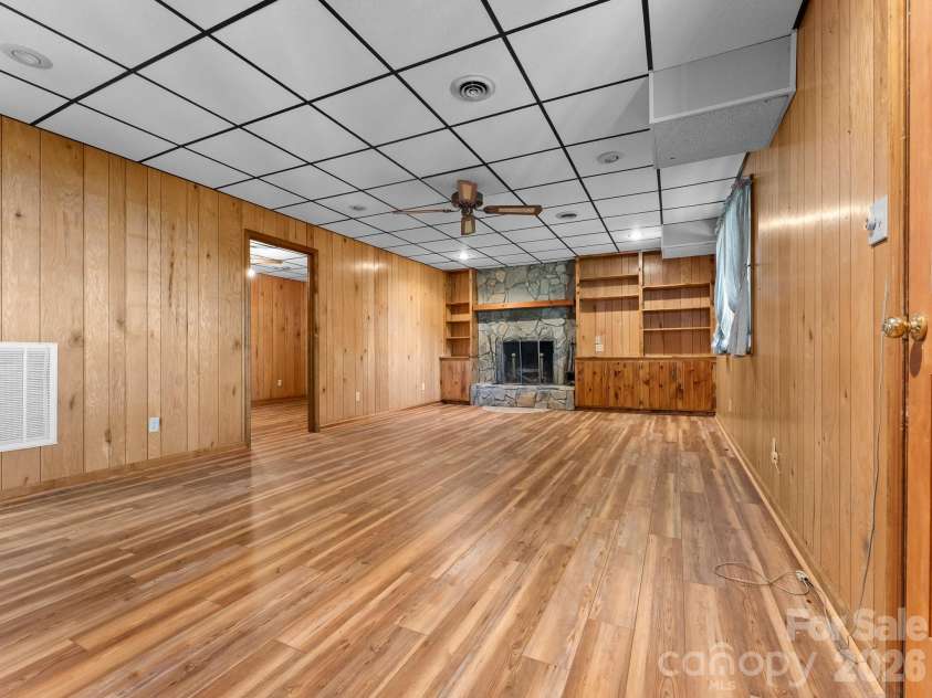 977 Morning Ride Drive, Columbus, NC 28722.  MLS# CAR4419017, YatesRealty ID 49673. Den with Wood Fireplace