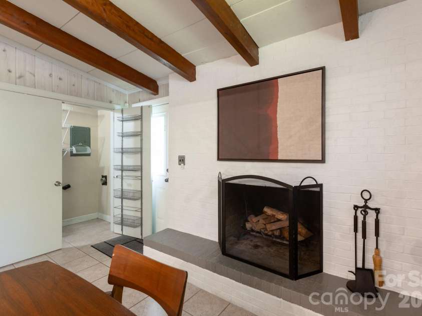 1526 Briarfield Drive, Charlotte, NC 28205.  MLS# CAR4422287, YatesRealty ID 49726. Brick fireplace and pantry storage.