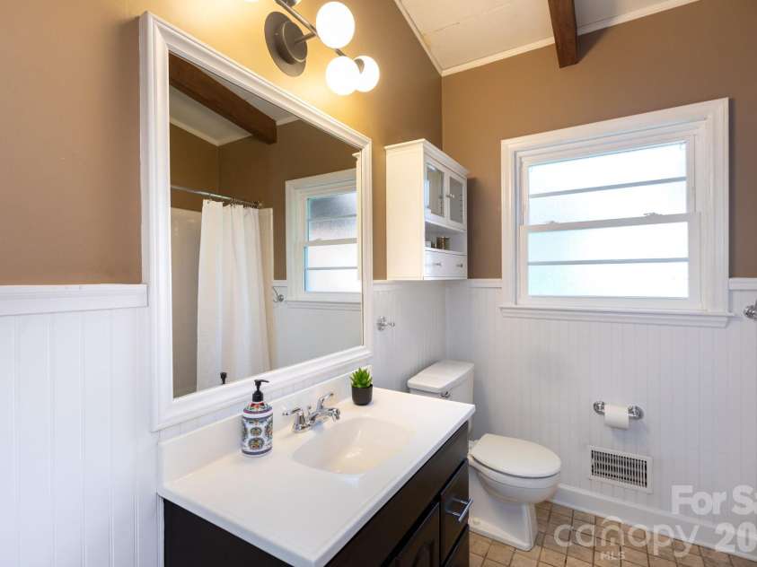 1526 Briarfield Drive, Charlotte, NC 28205.  MLS# CAR4422287, YatesRealty ID 49726. Updated vanity with classic beadboard detail.
