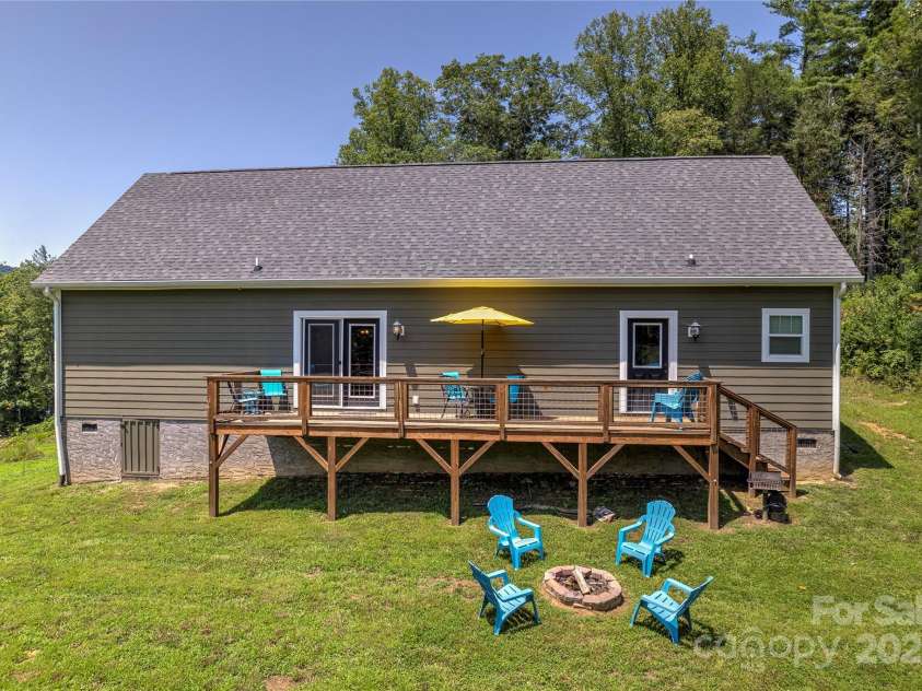 115 Cascade Ridge Road, Fairview, NC 28730.  MLS# CAR4222933, YatesRealty ID 4973. Backyard with fire pit and deck