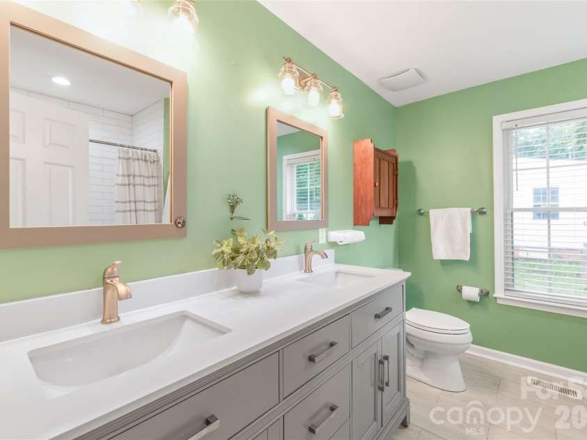 910 Beverly Drive, Rock Hill, SC 29730.  MLS# CAR4421788, YatesRealty ID 49769. A stylishly updated primary bathroom designed for daily relaxation, featuring contemporary fixtures, updated tile work, and crisp, modern finishes.