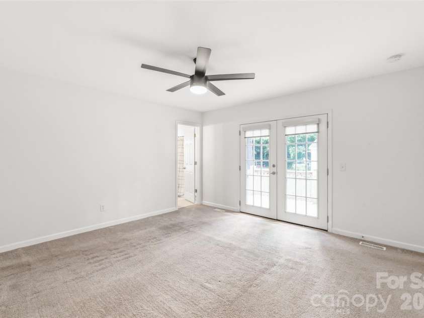910 Beverly Drive, Rock Hill, SC 29730.  MLS# CAR4421788, YatesRealty ID 49769. Double doors in the primary bedroom offer direct access to the private back deck, enhancing natural light and indoor.