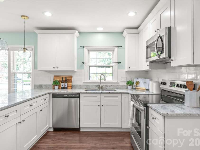 910 Beverly Drive, Rock Hill, SC 29730.  MLS# CAR4421788, YatesRealty ID 49769. Outfitted with quartz countertops, timeless tile backsplash, and stylish designer pendant lighting that perfectly complements the white shaker cabinetry.