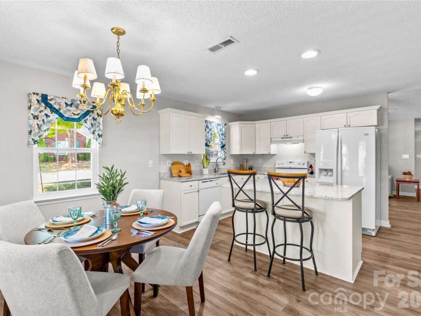 143 Ashwood Lane, Mooresville, NC 28117.  MLS# CAR4349646, YatesRealty ID 4979. Dining, Kitchen and Living Room open to one another and Porch off of Dining area