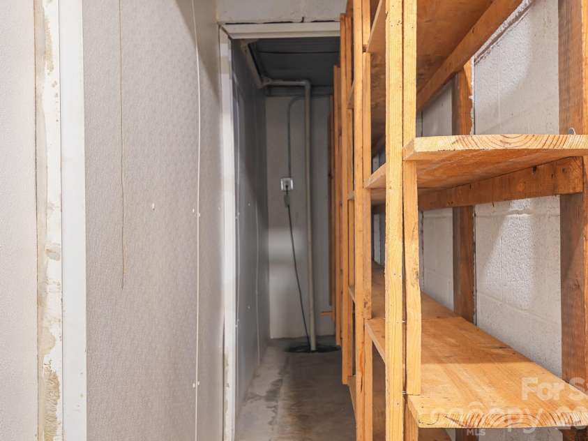 316 Hudson Drive, Harrisburg, NC 28075.  MLS# CAR4420210, YatesRealty ID 49798. Basement storage space under front porch area.