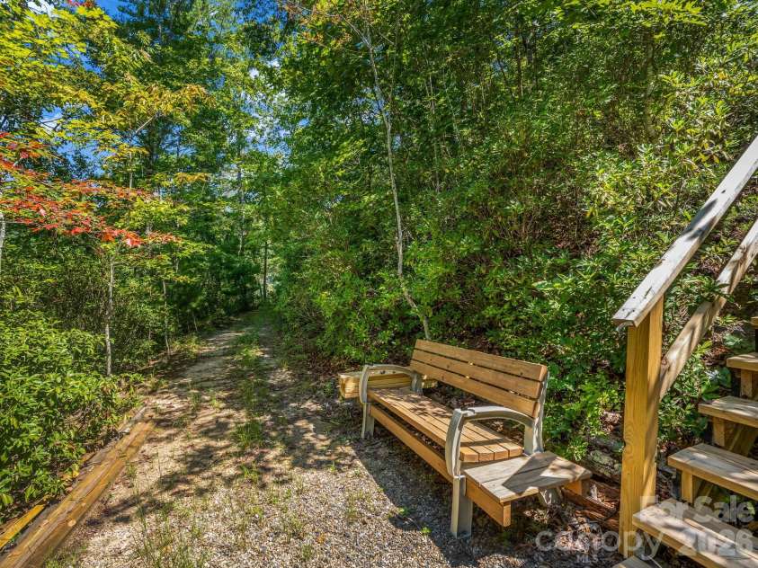 1237 South Cove Road, Mill Spring, NC 28756.  MLS# CAR4421708, YatesRealty ID 49838. Sit a while and enjoy the walkway to the lake.