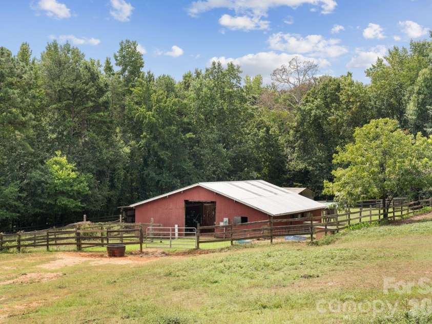 160 Palomino Trail, Mount Holly, NC 28120.  MLS# CAR4422505, YatesRealty ID 49841. 6 stall barn with center aisle