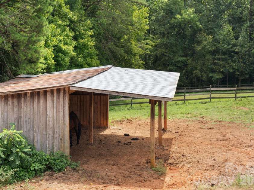 160 Palomino Trail, Mount Holly, NC 28120.  MLS# CAR4422505, YatesRealty ID 49841. Run in sheds in pastures