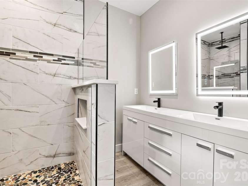 156 Edwards Avenue, Swannanoa, NC 28778.  MLS# CAR4422334, YatesRealty ID 49847. Walk in shower with river-rock and tile and double sinks