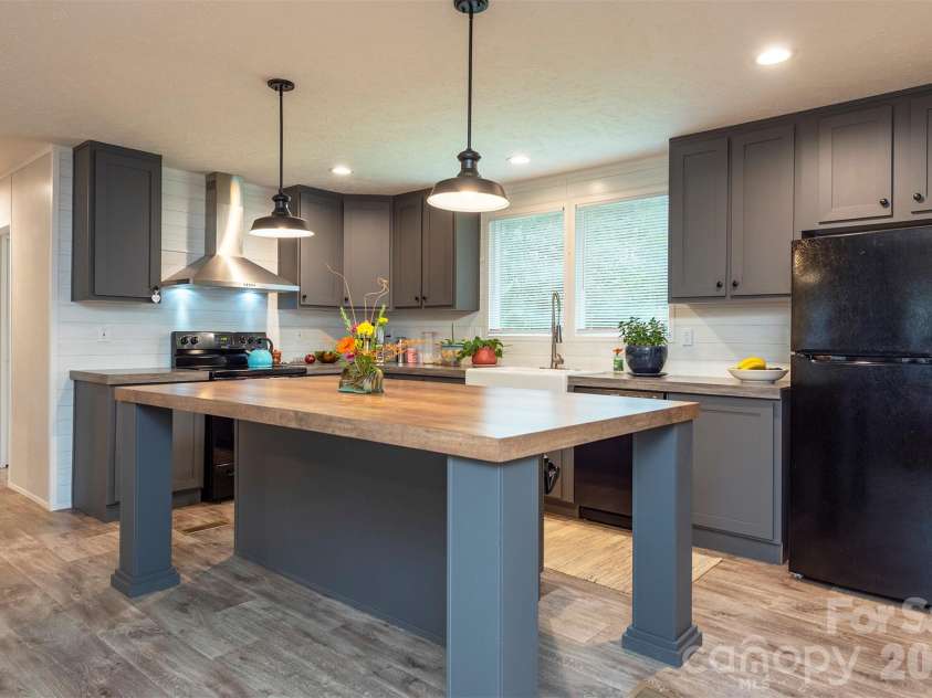 346 Tricycle Hill Lane, Tryon, NC 28782.  MLS# CAR4419540, YatesRealty ID 49859. A generous kitchen island offers ample workspace and seating