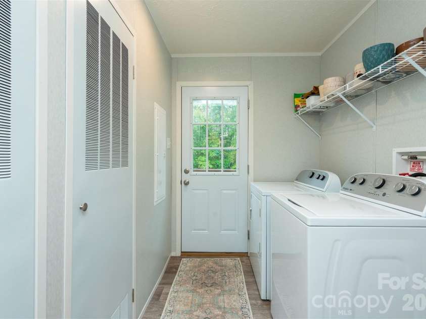 346 Tricycle Hill Lane, Tryon, NC 28782.  MLS# CAR4419540, YatesRealty ID 49859. A generously sized laundry room leading to the backyard