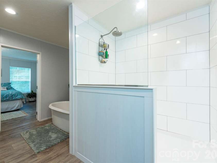 346 Tricycle Hill Lane, Tryon, NC 28782.  MLS# CAR4419540, YatesRealty ID 49859. A large, beautifully tiled walk in shower