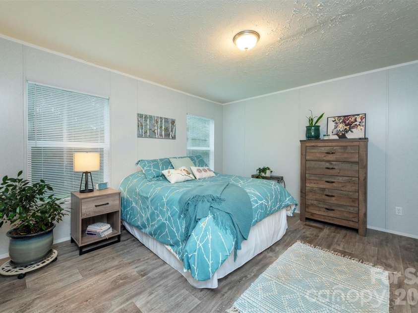 346 Tricycle Hill Lane, Tryon, NC 28782.  MLS# CAR4419540, YatesRealty ID 49859. A spacious primary bedroom