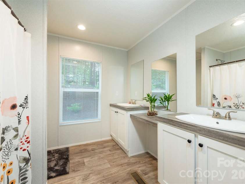 346 Tricycle Hill Lane, Tryon, NC 28782.  MLS# CAR4419540, YatesRealty ID 49859. The guest bathroom with double sinks