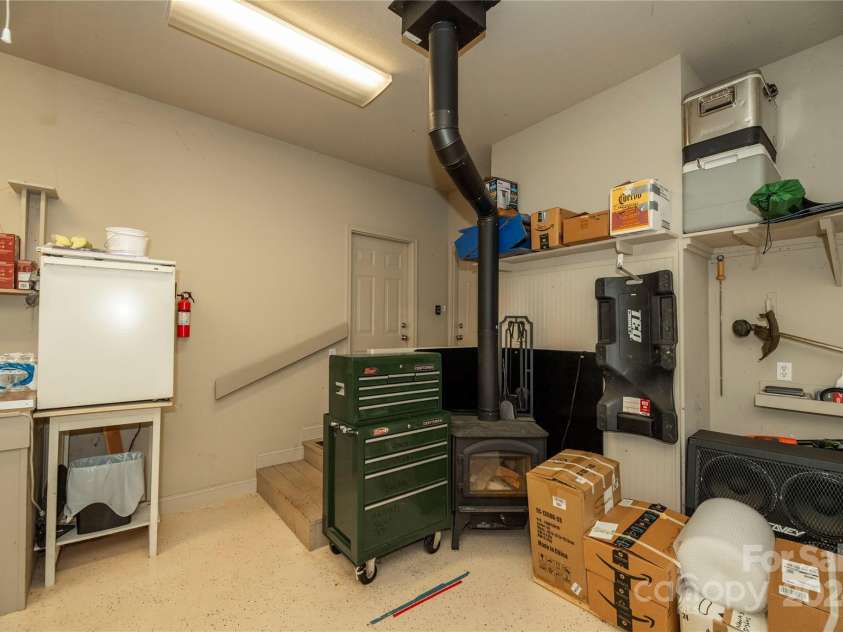 1244 Windover Drive, Brevard, NC 28712.  MLS# CAR4169991, YatesRealty ID 4987. Wood Burning Fireplace in Garage. You Can Access Both the Pantry From the Garage As Well As