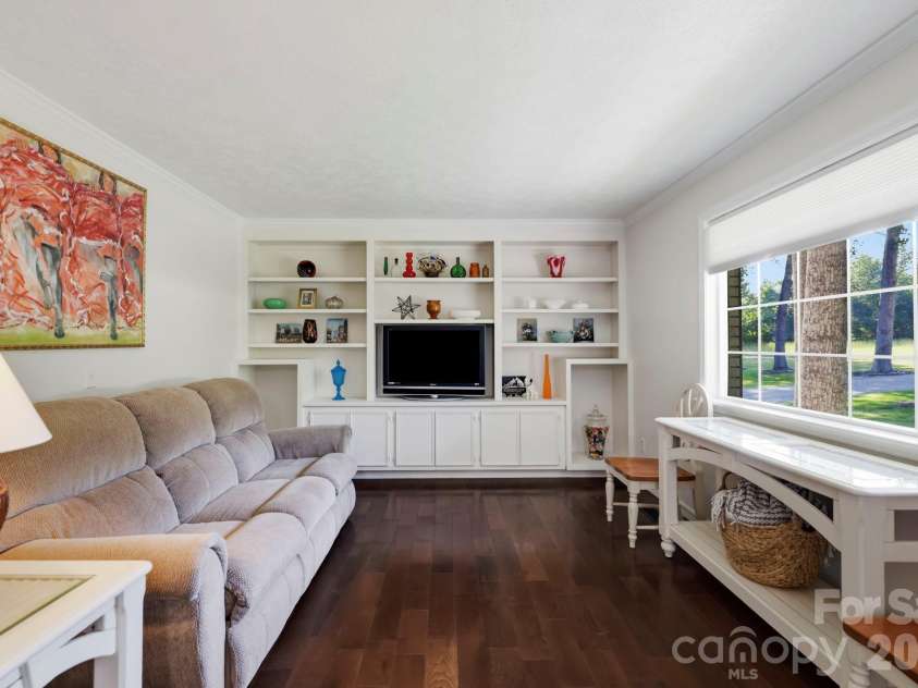 168 Country Lane, Mills River, NC 28759.  MLS# CAR4422309, YatesRealty ID 49874. Custom built-ins provide attractive display and storage space while a large picture window fills the room with natural light.