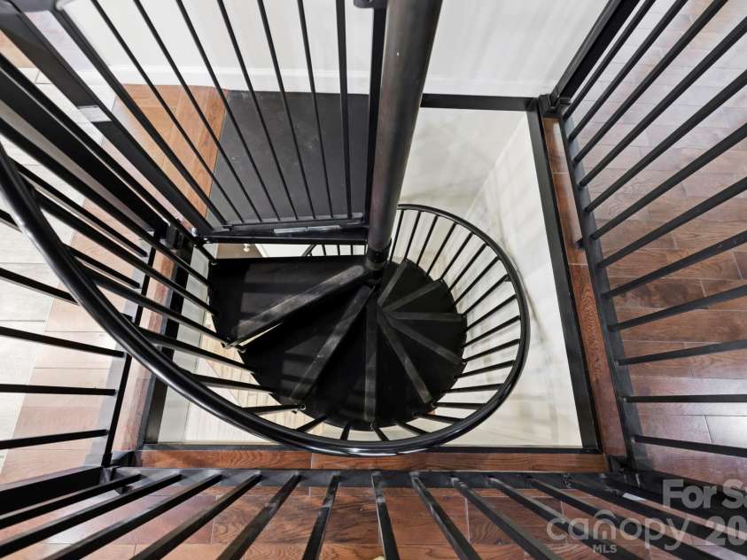 168 Country Lane, Mills River, NC 28759.  MLS# CAR4422309, YatesRealty ID 49874. Distinctive spiral staircase provides access between the main level and the flexible lower-level living space.