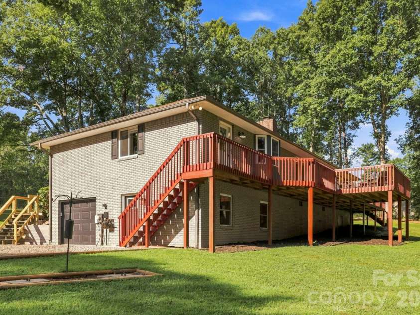 168 Country Lane, Mills River, NC 28759.  MLS# CAR4422309, YatesRealty ID 49874. Expansive rear decking provides multiple areas for relaxing, entertaining, and enjoying the peaceful surroundings.