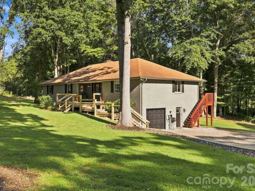 168 Country Lane, Mills River, NC 28759.  MLS# CAR4422309, YatesRealty ID 49874. Lower-level garage and exterior access complement the home's versatile two-level layout.