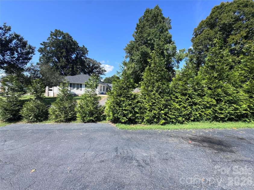 106 Myrtle Street, Morganton, NC 28655.  MLS# CAR4422677, YatesRealty ID 49887. Driveway w/privacy hedge
