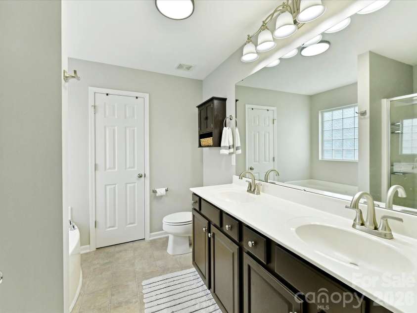 9338 Atlas Cedar Drive, Charlotte, NC 28215.  MLS# CAR4422993, YatesRealty ID 49889. Primary bathroom features a dual-sink vanity with ample counter space and storage.