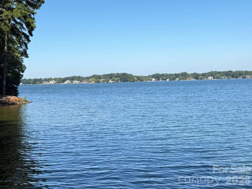 327 Northwest Drive, Davidson, NC 28036.  MLS# CAR4423032, YatesRealty ID 49906. Lake edge view mid day