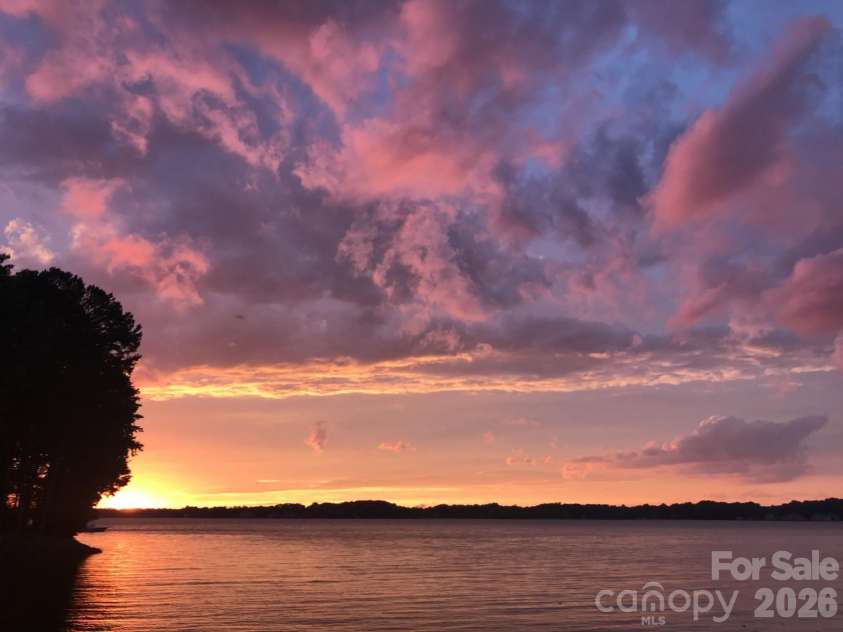 327 Northwest Drive, Davidson, NC 28036.  MLS# CAR4423032, YatesRealty ID 49906. Sunset view from your Lake edge