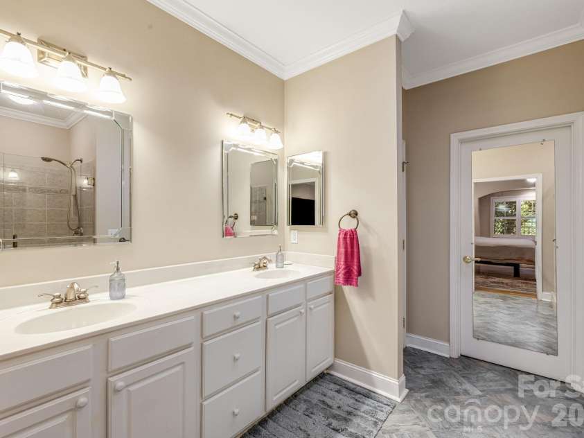 212 Carriage Springs Way, Hendersonville, NC 28791.  MLS# CAR4420645, YatesRealty ID 49923. Dual vanity sinks with a water closet.