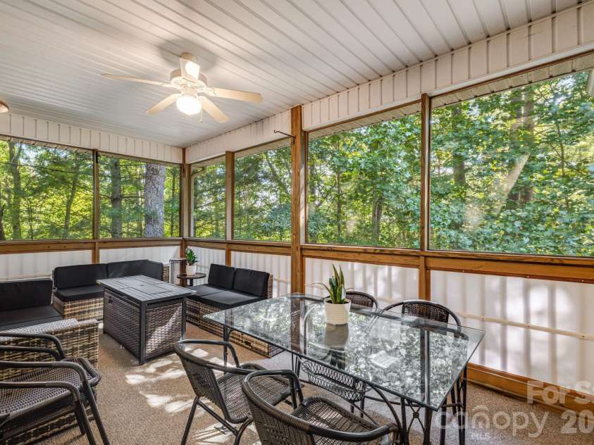 212 Carriage Springs Way, Hendersonville, NC 28791.  MLS# CAR4420645, YatesRealty ID 49923. Top level screened deck with added privacy screens.
