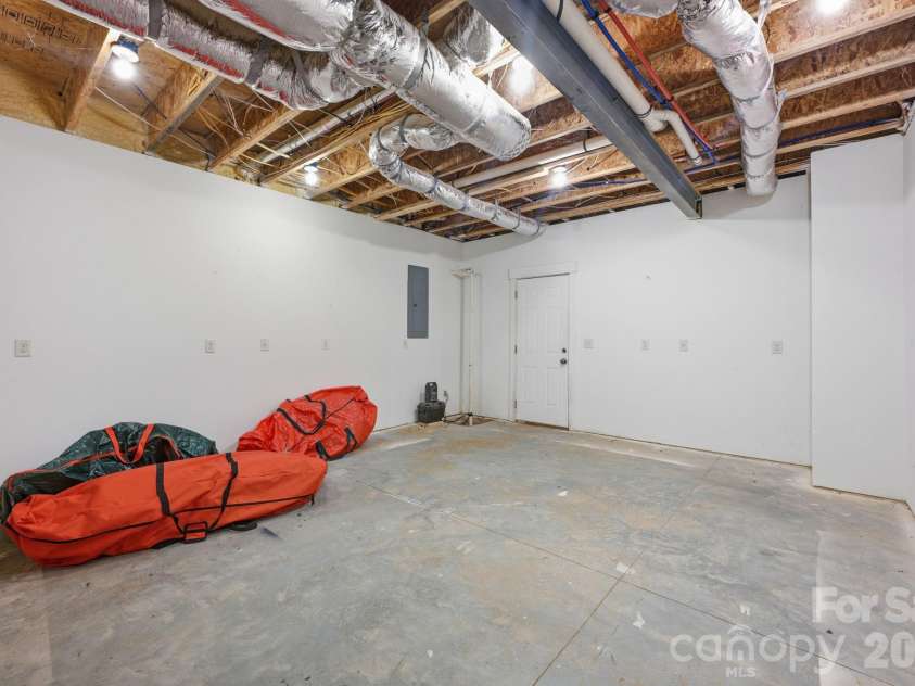 415 Goodrum Street, Davidson, NC 28036.  MLS# CAR4423264, YatesRealty ID 49977. Basement workshop and storage area.