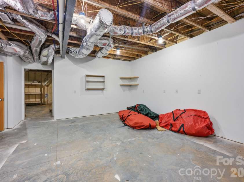 415 Goodrum Street, Davidson, NC 28036.  MLS# CAR4423264, YatesRealty ID 49977. Basement workshop and storage area