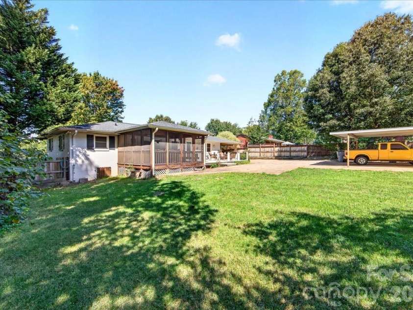 1442 Plumcrest Drive, Charlotte, NC 28216.  MLS# CAR4422358, YatesRealty ID 49987. Backyard looking towards the house