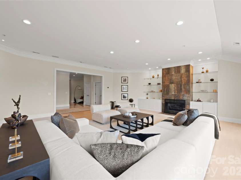 974 Queens Road, Charlotte, NC 28207.  MLS# CAR4413389, YatesRealty ID 50053. A dramatic floor-to-ceiling fireplace, custom cabinetry and floating shelves create a distinctive focal point in this sophisticated great room.