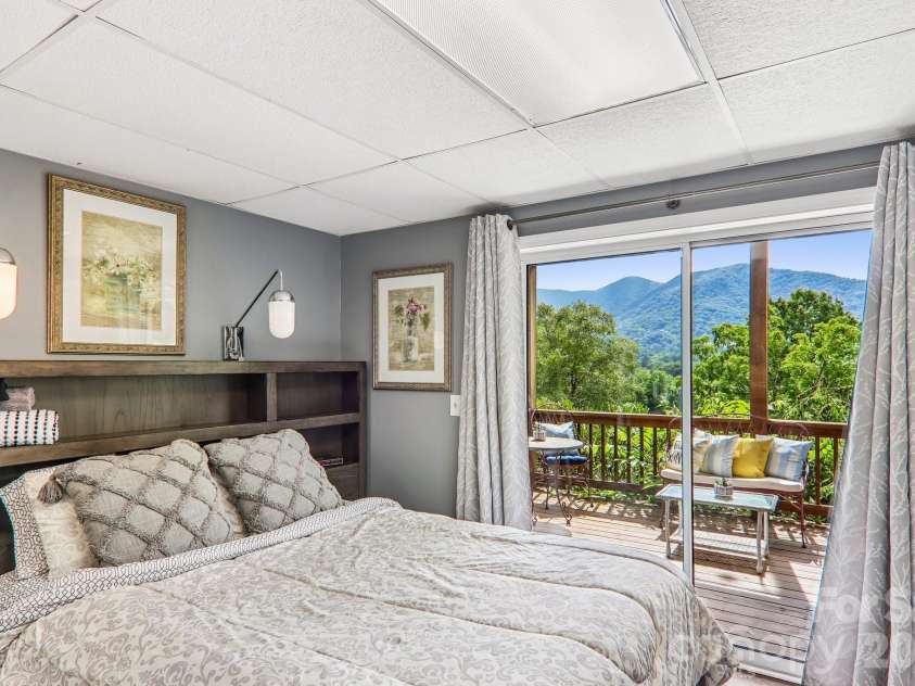169 Highview Drive, Maggie Valley, NC 28751.  MLS# CAR4411083, YatesRealty ID 50102. Light-filled lower bedroom with mountain views!